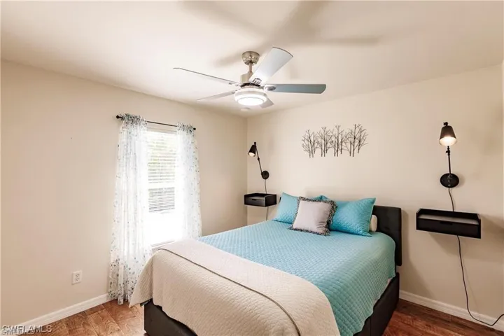 Bedroom with wood finished floors and ceiling fan