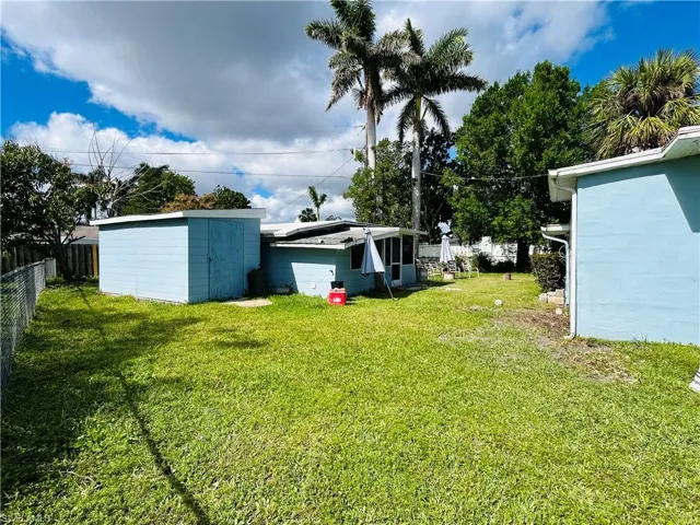 View of rear yard with fence and shared utility room.