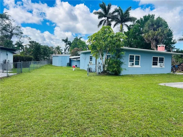 View of left front yard featuring a fenced backyard