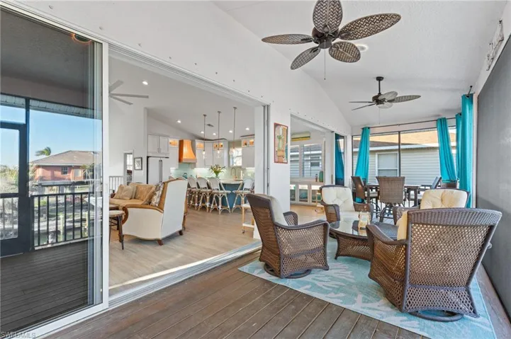 Sunroom with vaulted ceiling, ceiling fan, and plenty of natural light