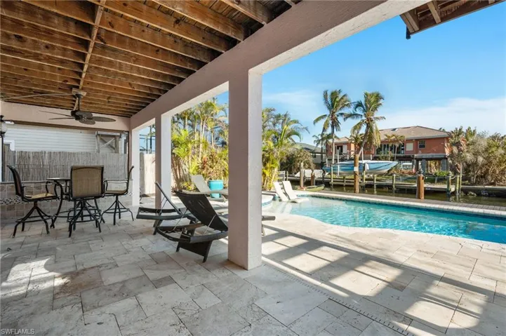 View of swimming pool with a patio and ceiling fan