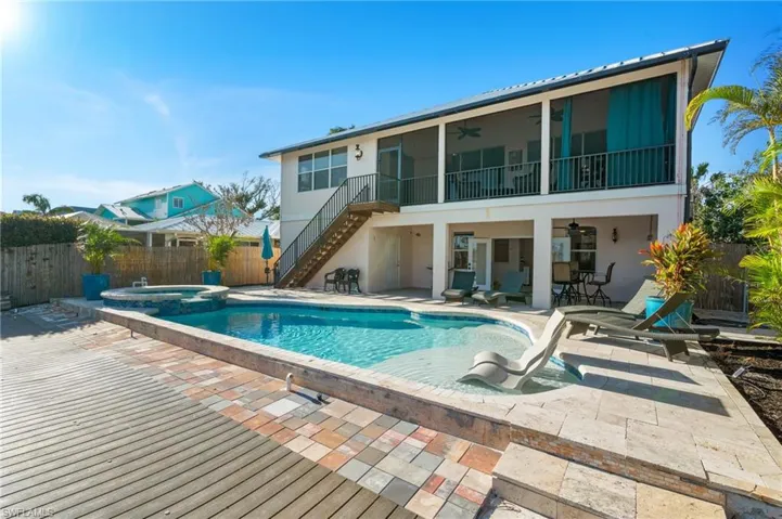 View of swimming pool featuring an in ground hot tub, a sunroom, ceiling fan, and a patio area