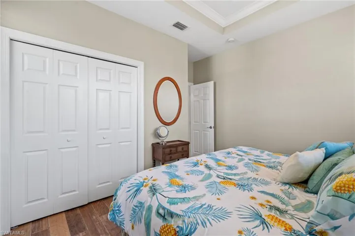 Bedroom featuring crown molding and a closet