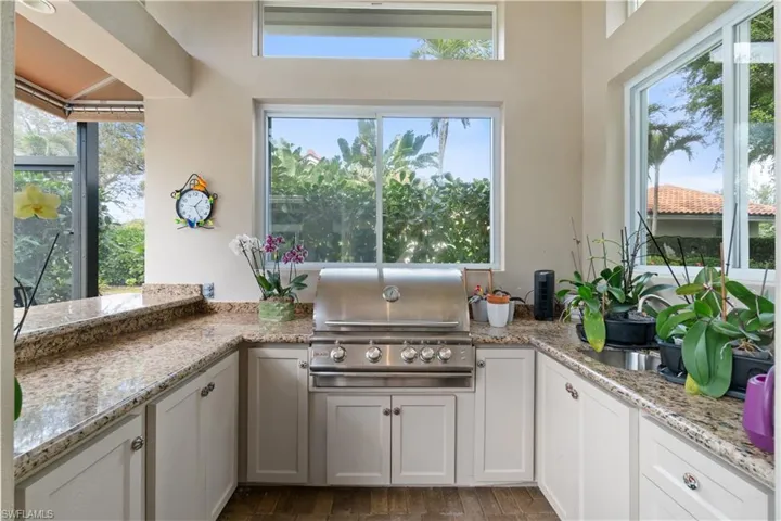 Outdoor kitchen & bar with awning.