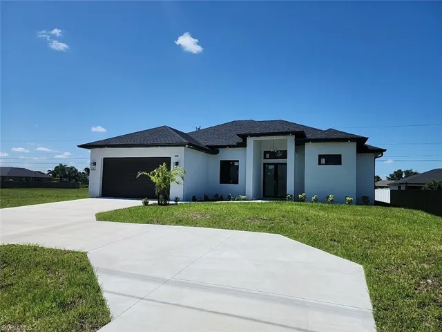 Prairie-style house with a garage and a front yard