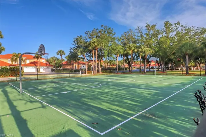 View of basketball court featuring fence and community basketball court