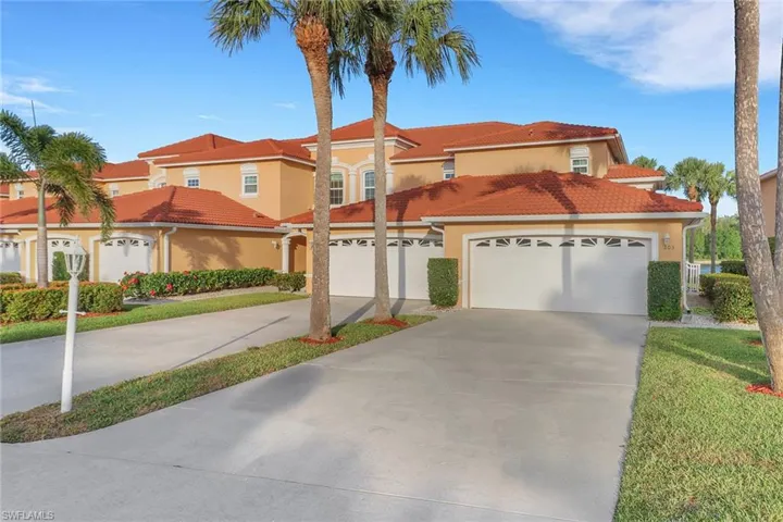 Mediterranean / spanish home with driveway, a garage, a tiled roof, and stucco siding