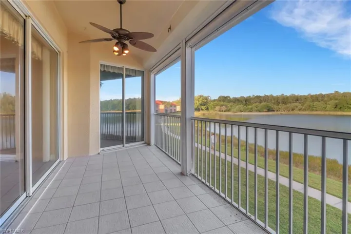 Beautiful sunset views overlooking a water view and a ceiling fan