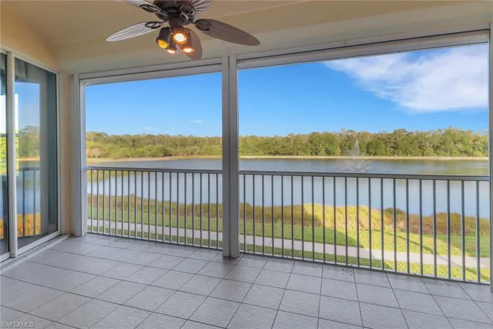 Screened in lanai featuring a beautiful lake with sunset views