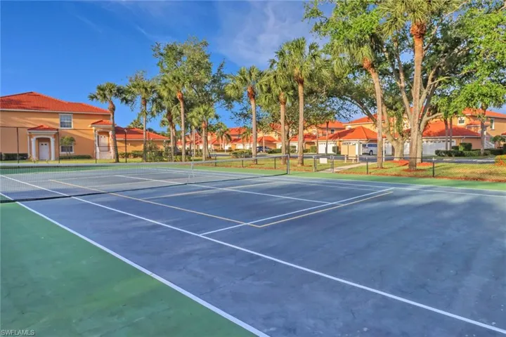 View of sport court with community basketball court, fence, and a residential view