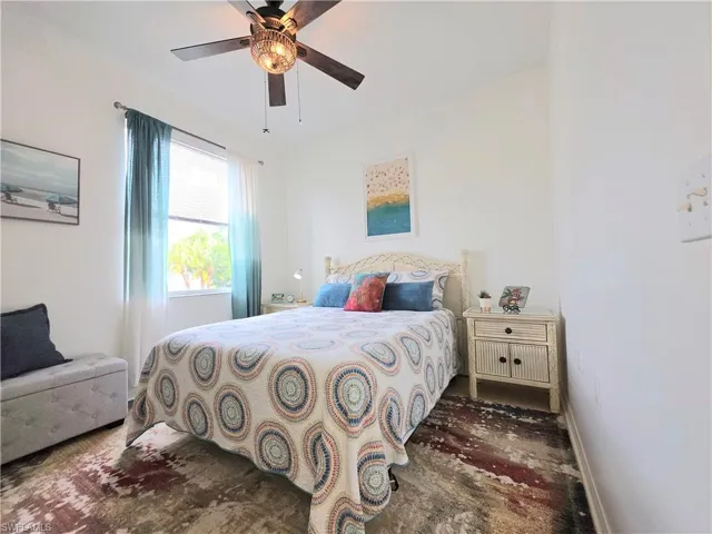Bedroom featuring ceiling fan and baseboards