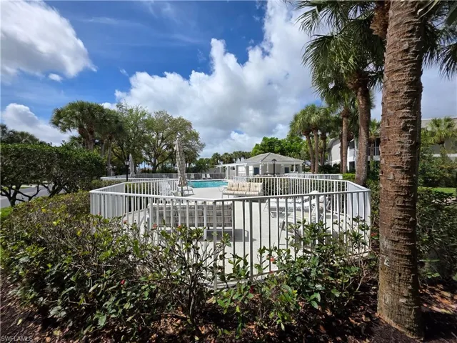 Community pool with a patio area and a deck