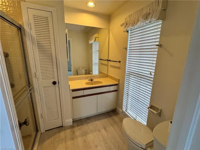 Bathroom featuring a vanity with a light-colored countertop, an integrated sink, and white cabinetry