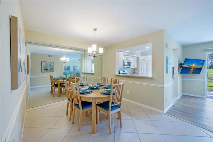 Formal Dining Area with Custom Mirror, Passthrough to Kitchen, with tile flooring