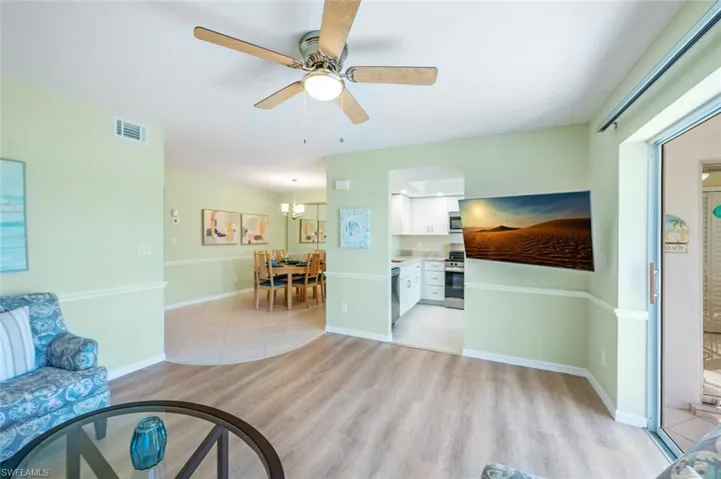 Living Room with View of Tiled Formal Dining Area and Kitchen Entry
