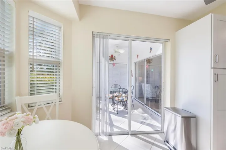 Slider from Kitchen to Lanai with New Blinds on All Windows.  Three Bay Windows 2023 are Impact Glass with New Marble Sills Also