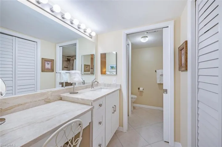 Primary Bath with Taj Mahal Quartzite countertop with attached makeup counter