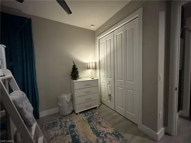 Bedroom featuring a closet, wood finished looking floors, and a ceiling fan