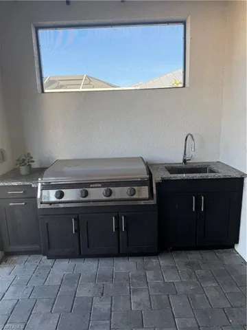 View of patio / terrace featuring area for grilling and a sink