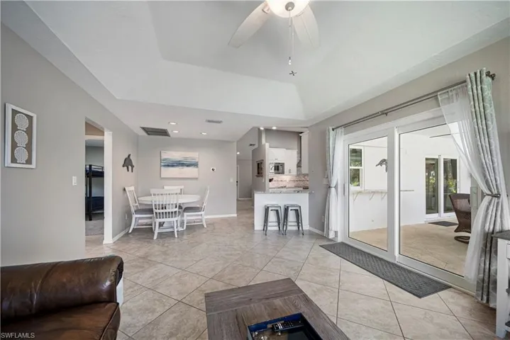 Living room featuring ceiling fan and light tile patterned floors