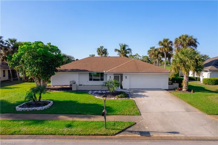 Ranch-style home featuring a garage and a front yard