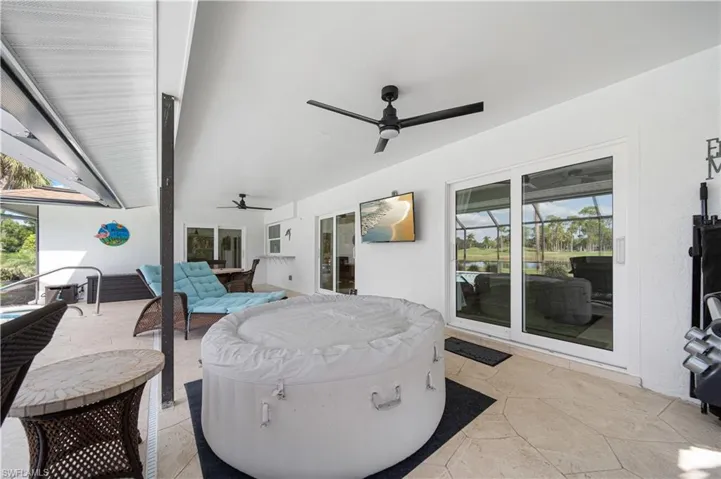 View of patio / terrace with an outdoor hangout area, a hot tub, and ceiling fan