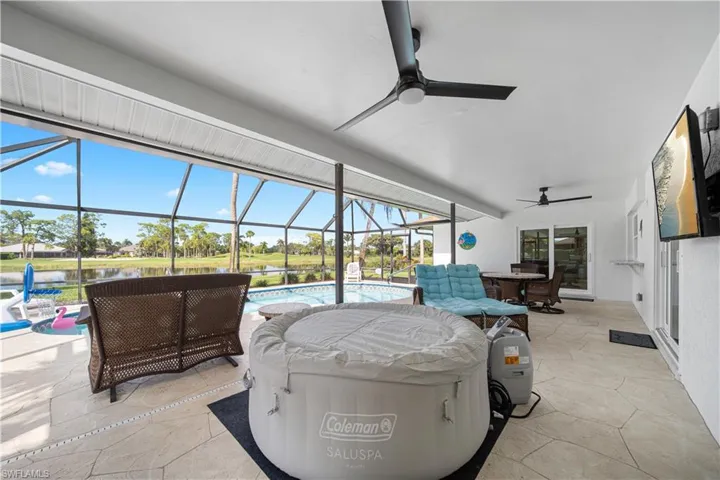 Sunroom / solarium featuring a water view and ceiling fan