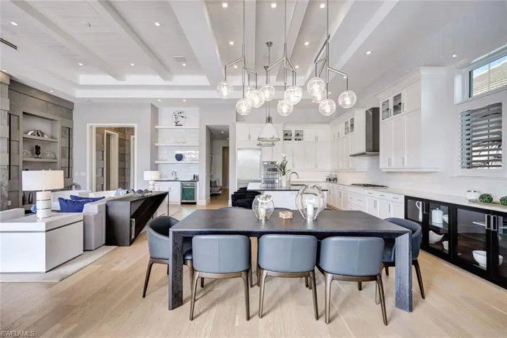 Dining space featuring beam ceiling, light hardwood / wood-style flooring, and built in features
