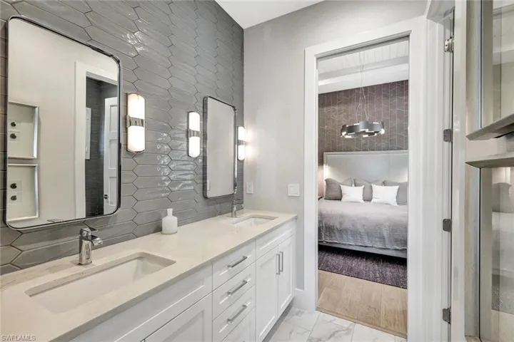 Bathroom with decorative backsplash, vanity, and hardwood / wood-style flooring