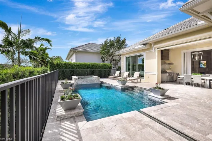View of pool with an outdoor kitchen, a patio area, and an in ground hot tub