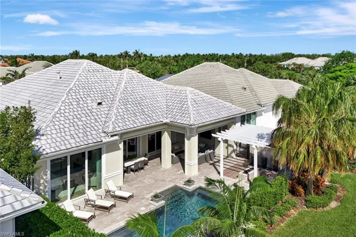 Back of property with a pergola, an outdoor living space, and a patio