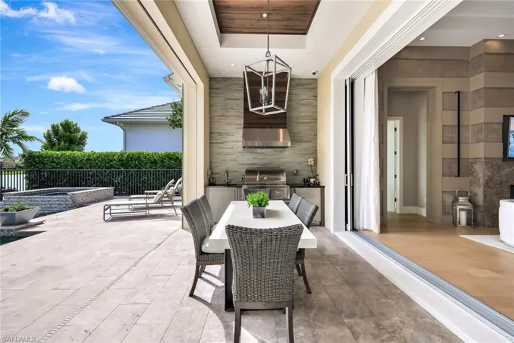 View of patio / terrace featuring an in ground hot tub, area for grilling, grilling area, and sink