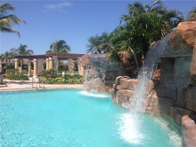 Community pool with a pergola and a patio area