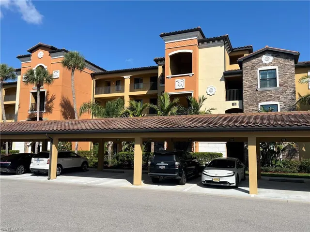 View of property with covered parking