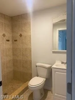 Full bath featuring vanity, tile patterned floors, and a tile shower