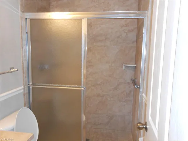 Bathroom featuring a shower stall and vanity