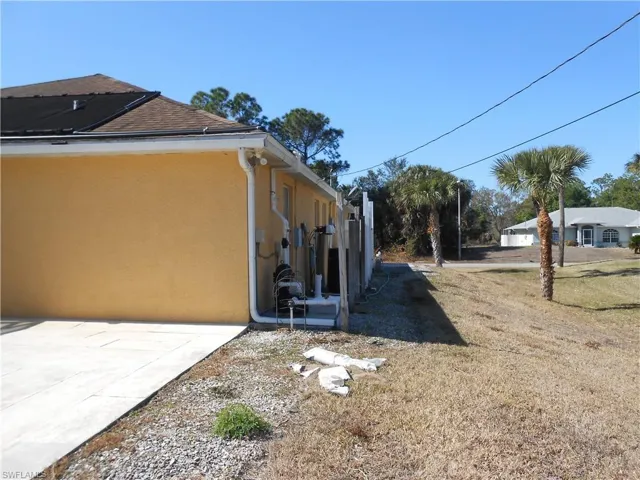 View of home's exterior featuring stucco siding and a yard