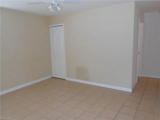 Unfurnished room featuring ceiling fan and light tile patterned flooring