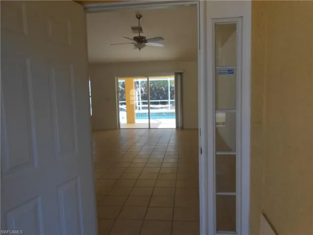 Hall with light tile patterned floors