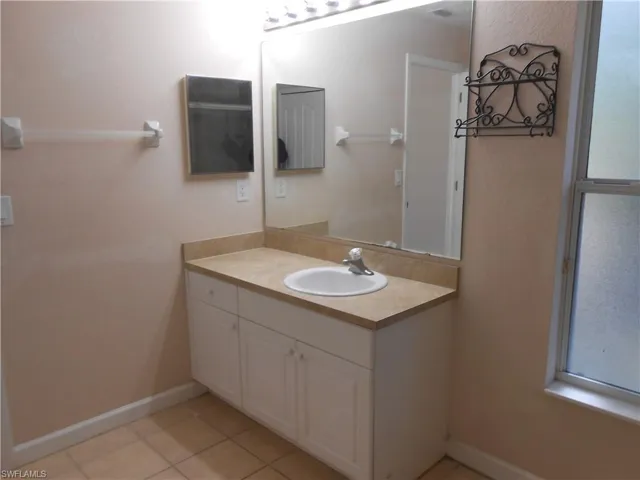 Bathroom with vanity and light tile patterned floors