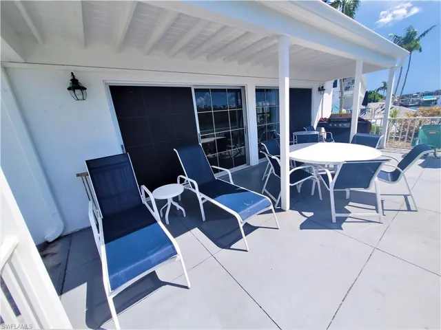 View of patio / terrace featuring outdoor dining space and a grill
