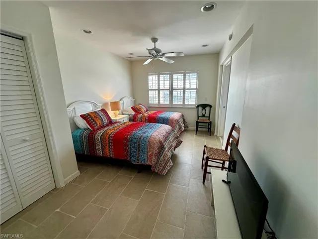 Bedroom with a closet, ceiling fan, and recessed lighting