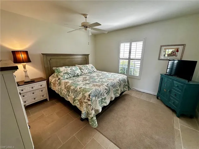 Bedroom with a ceiling fan and light tile patterned floors