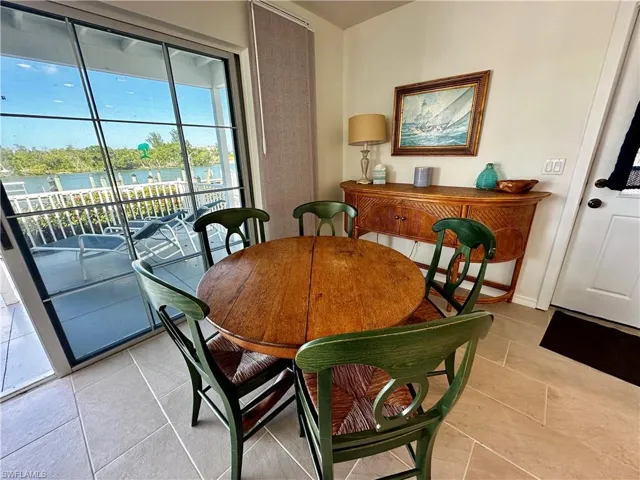 Dining area with a water view and light tile patterned floors