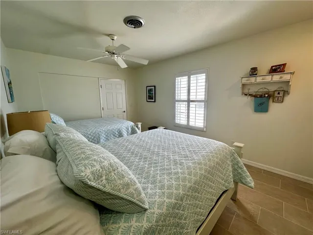 Bedroom featuring ceiling fan and tile patterned flooring