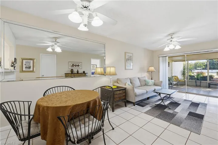 Living area featuring light tile patterned floors and a ceiling fan