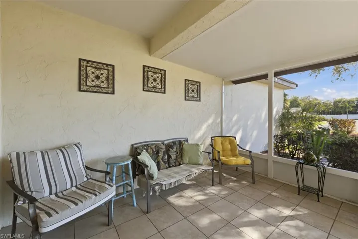 Sunroom with a textured wall and tile patterned floors