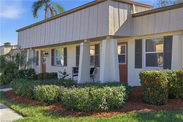 View of front facade featuring stucco siding, board and batten siding, and a porch