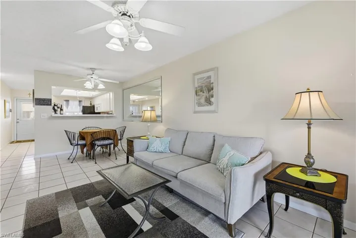 Living area with light tile patterned flooring and a ceiling fan