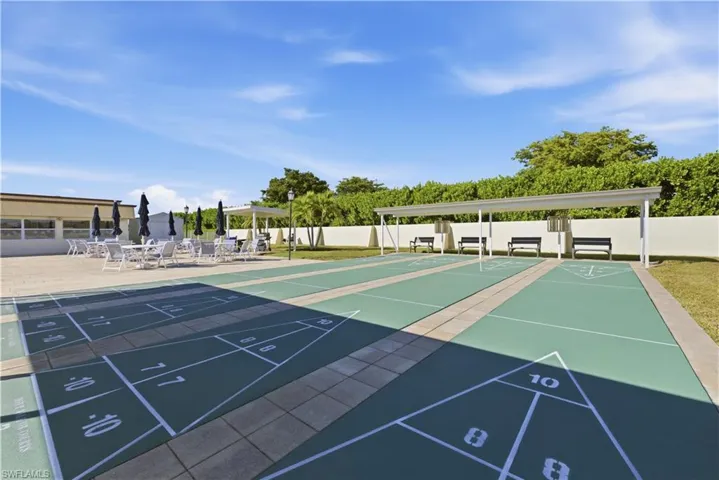 View of property's community featuring shuffleboard